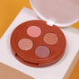 The Everyday For Future Coffee Oil Infused Pigmented Eyeshadow Palette features four clean beauty shades—matte pink, shimmery bronze, shimmery rose gold, and matte mauve—in a round reddish-brown case, shown on white with a yellow backdrop.