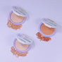 Three open compacts of Everyday For Future Nourishing Blueberry Infused Highlighter rest on a light purple surface, with scattered powder. Each compact features a purple lid adorned with floral designs for charming appeal.