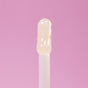 Everyday For Future’s Moisturizing & Non-Sticky Coconut Lip Oil appears glossy and clear on a white applicator wand, set against a solid pink background.