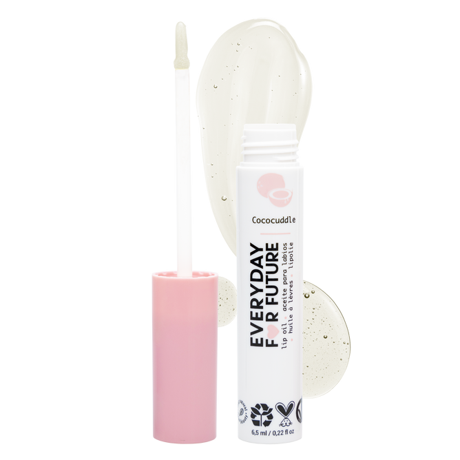 The Everyday For Future Moisturizing & Non-Sticky Coconut Lip Oil in Cococuddle is shown with a pink cap, white applicator, and a smear of its clear, glossy formula enriched with organic argan and coconut oils on a white background.