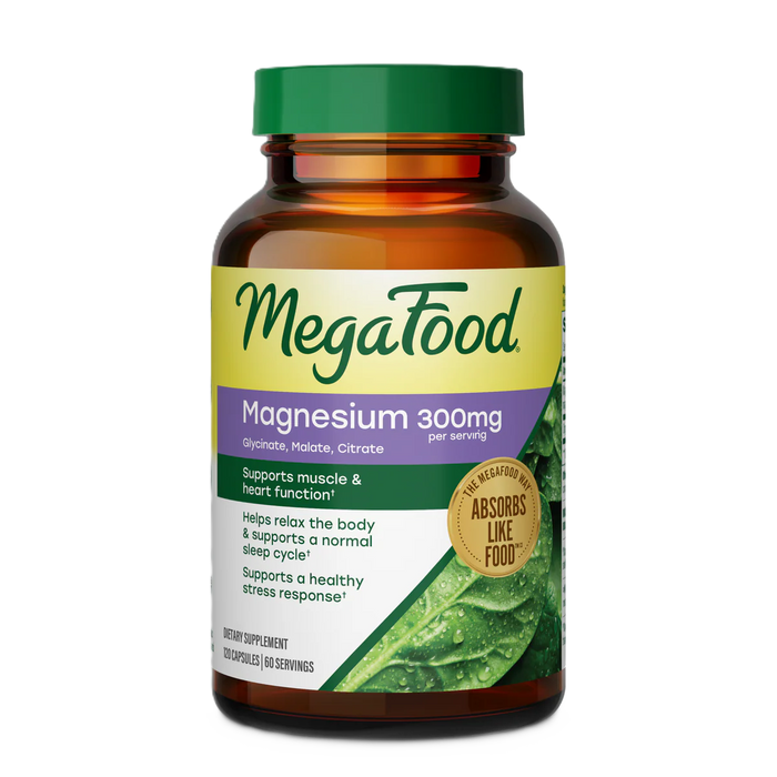 A brown bottle of MegaFood Magnesium 300 mg Capsules with a green and purple label, featuring benefits for muscle, heart, sleep, and stress support. This triple magnesium complex, including magnesium glycinate, is formulated for optimal absorption—Absorbs Like Food.