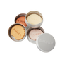 Four round metal tins of Ember Wellness The Complete Minibar Set, three opened to reveal solid moisturizing bars in peach, gold, off-white, and pale pink shades—perfect as a mini bar set or for highlighting—with EMBER stamped on each tin.