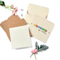 The Elseware Unplug Flower Press DIY kit features blank sheets, brown envelopes, wooden covers labeled "Elseware Mangle," metal rings, and pink pressed flowers, all set on a white background.
