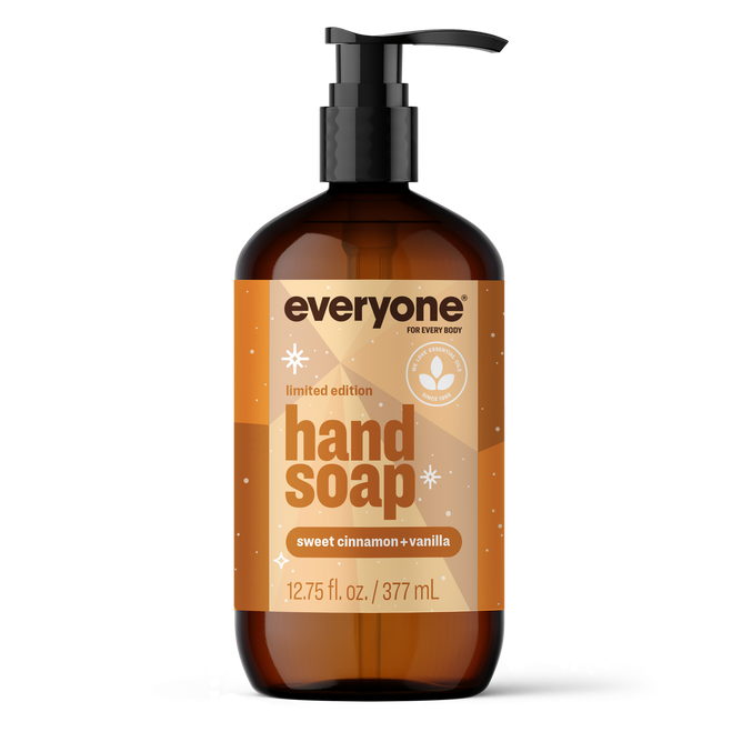 A 12.75 fl. oz. pump bottle of Everyone Hand Soap, a limited edition with a sweet cinnamon and vanilla scent inspired by holiday fragrances, crafted with essential oil blends. The orange label features white and brown text, small stars, and a leaf icon.