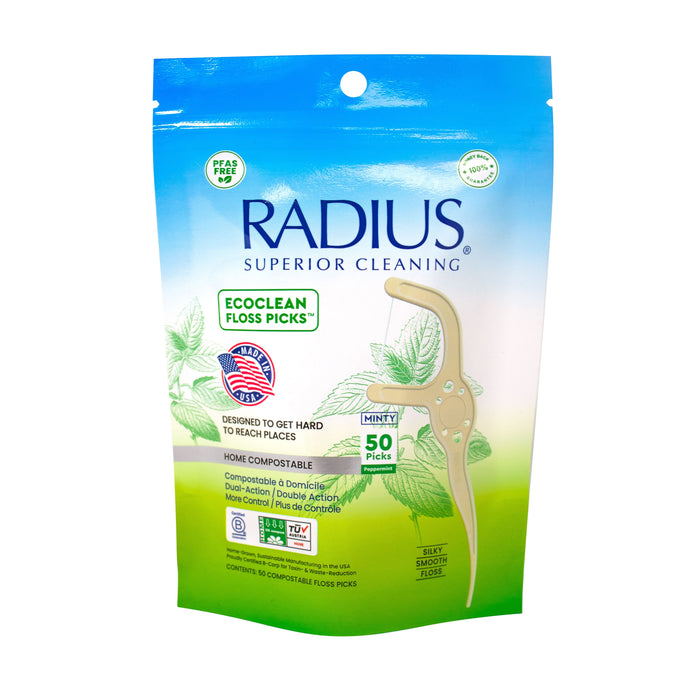 A 50-count pack of Radius EcoClean Floss Picks with Toothpick End in mint flavor features green leaves and product info. These sustainable, home-compostable picks offer a dual-function design for eco-friendly oral care.