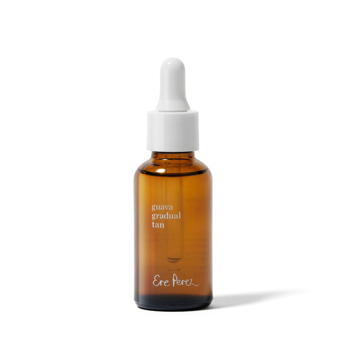 A brown glass dropper bottle with a white cap, labeled "Guava Gradual Tan" by Ere Perez, contains a sunless facial tanning serum and is displayed on a clean white background.