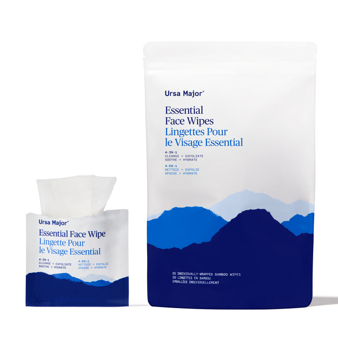 A packet and a pouch of Ursa Major Essential Face Wipes with blue mountain graphics, white background, bilingual text, and one bamboo wipe partially pulled out.