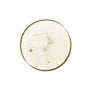 Close-up of a clear, pale yellow drop of Everist EverBoost Multi-Peptide Scalp Serum with small bubbles, viewed from above on a white background—ideal for promoting fuller-looking hair.