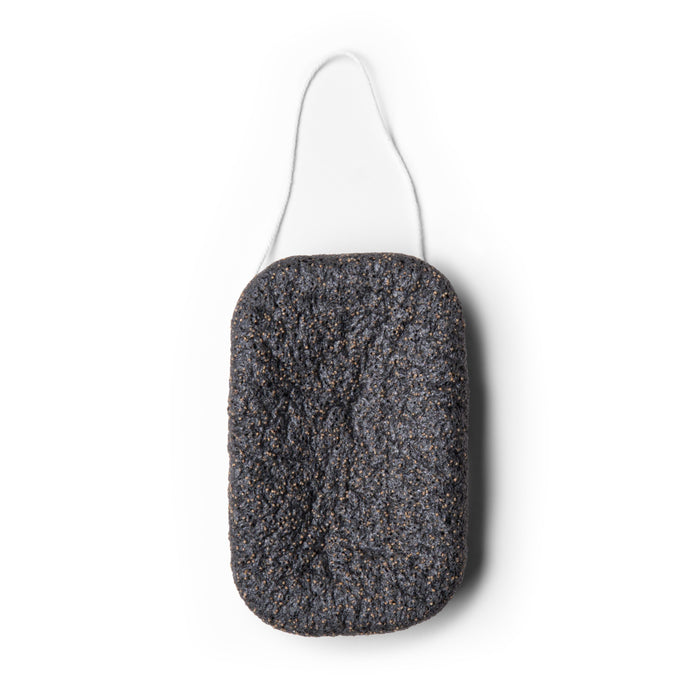 The Exfoliating Konjac Body Sponge by Everist is a rectangular black sponge with a rough texture, rounded corners, and a white hanging string, designed for exfoliating and detoxifying skin.