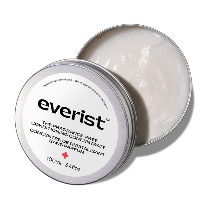 A round, open metal tin of Everist The Fragrance-Free Conditioning Concentrate contains a creamy white deep hydration formula. The lid is partially on top. Size: 100 mL (3.4 fl oz).