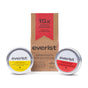 Two tins from Everist’s The Haircare Travel Duo—shampoo and deep conditioner—are displayed in front of a brown Everist box featuring the “15x Award Winning Haircare Concentrates” badge.