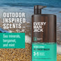 Every Man Jack 3-in-1 All Over Wash, infused with Soy Protein, sits on a sandy beach. With outdoor-inspired scents like sea minerals, bergamot, and mint, it works as body wash, shampoo, and conditioner.