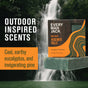 A box and bar of Every Man Jack Cold Plunge Bar Soap are shown before a lush waterfall. Text reads: Outdoor inspired scents with naturally derived ingredients. Cool, earthy eucalyptus, and invigorating pine.