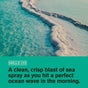 A foamy white wave rolls across turquoise water under a bright sky. Text below reads: “Smells like crisp sea spray as you hit the perfect wave—now in Every Man Jack Hydrating Body Wash for Men, made with naturally-derived ingredients.”.