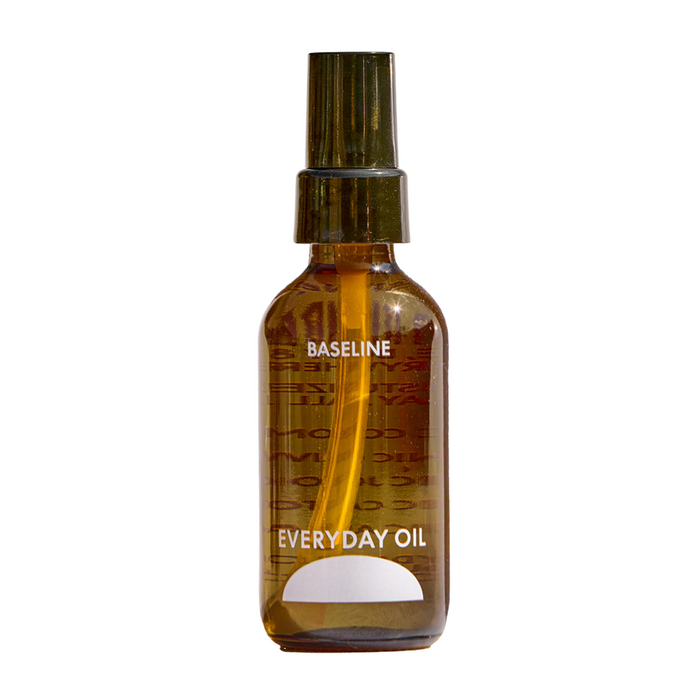 A brown glass spray bottle labeled Everyday Oil, Baseline Blend by Everyday Oil, filled with golden botanical oils, is shown against a plain white background.