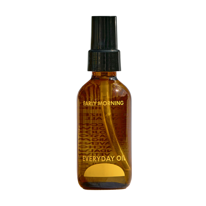 A brown glass spray bottle of Everyday Oil, Early Morning Blend by Everyday Oil, featuring botanical oils for organic skincare and a black plastic cap, shown against a white background.
