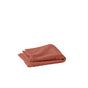 A folded, textured, reddish-brown Air Weight® Organic Towel by Coyuchi sits on a plain white background.