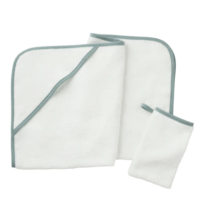 A folded white towel with green trim, an unfolded matching towel, and a small matching washcloth—expertly crafted from soft Turkish cotton—are displayed on a white background. Shown here is the Cloud Loom™ Organic Baby Hooded Towel and Bath Mitt Set by Coyuchi, designed for gentle, soothing care.