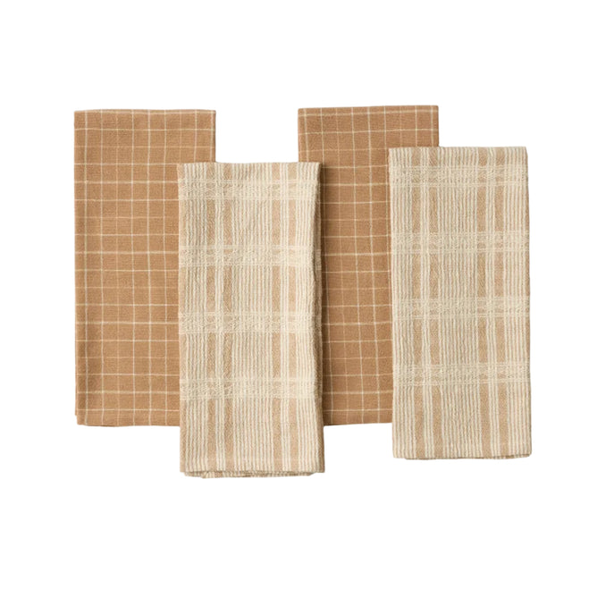 Four folded Coyuchi Clarendon Organic Kitchen Towels are arranged side by side—two in a brown and white checkered pattern, and two in a cream and white checkered pattern. Neatly stacked on a white background, this set of four highlights their GOTS certified cotton for an eco-friendly kitchen experience.