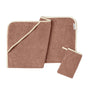 The Coyuchi Cloud Loom™ Organic Baby Hooded Towel and Bath Mitt Set, crafted from soft brown Turkish cotton with cream trim, features a folded hooded towel, a flat towel, and a small wash mitt with a loop—all shown against a white background.