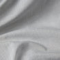 Close-up of Coyuchi’s Organic Crinkled Percale™ Duvet Cover in light gray, featuring GOTS Certified organic cotton with soft folds and a subtle woven texture that creates gentle shadows and highlights across the surface.