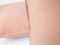 Two light pink Coyuchi Organic Crinkled Percale™ Shams are shown in close-up against a white background. The soft, smooth organic cotton fabric highlights the subtle texture and delicate color variations, making these shams an ideal complement to breathable bedding or an organic cotton sheet set.