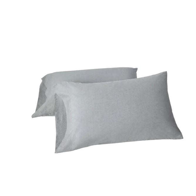 Two Coyuchi Organic Crinkled Percale™ Pillowcases in light gray, made from GOTS certified cotton, are stacked slightly overlapping on a plain white background.