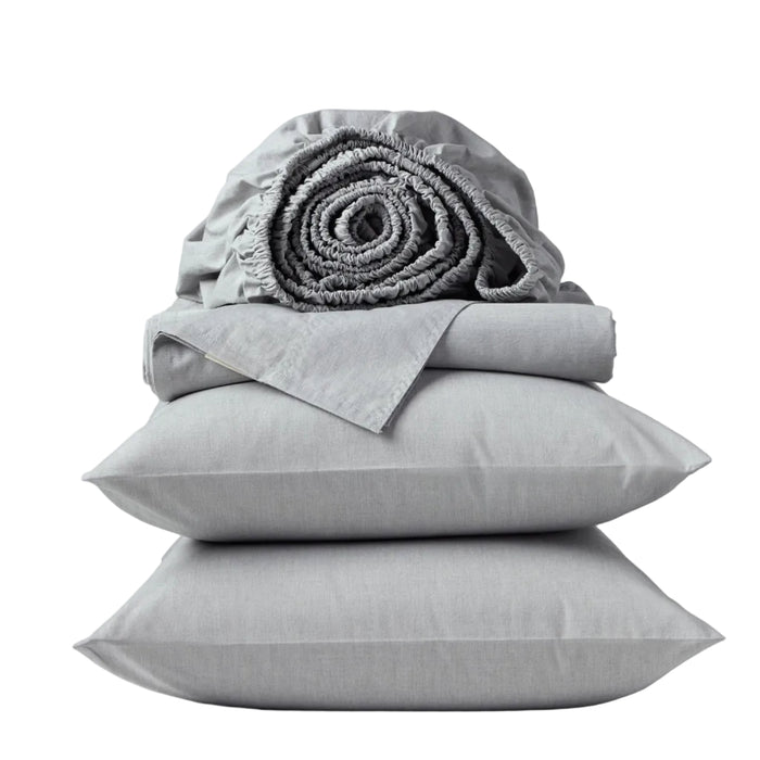 A neatly stacked set of Coyuchi’s Organic Crinkled Percale™ Sheet Set in light gray—including two pillows, a folded sheet, and a rolled fitted sheet—offers a breathable bedding experience and is displayed against a plain white background.
