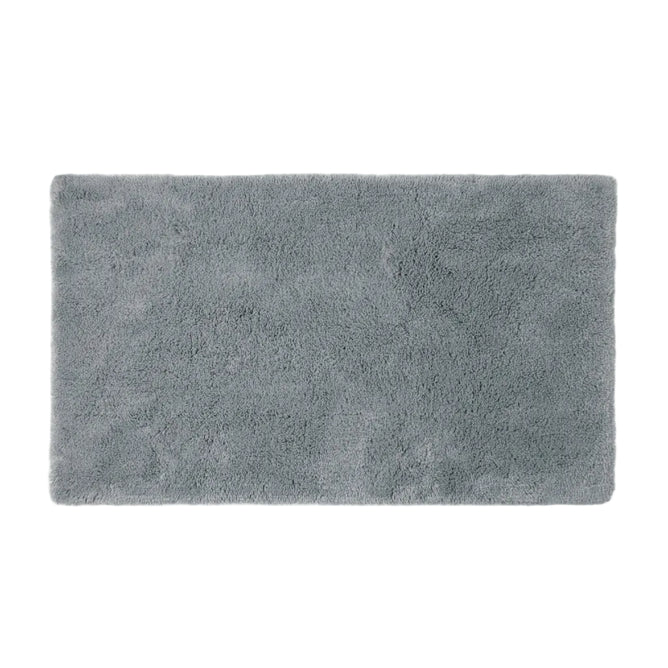The Shag Organic Bath Rug by Coyuchi, shown in a soft gray and rectangular shape against a plain white background, features a plush and fluffy texture that exudes comfort and warmth—making it an ideal choice for everyday luxury in your bathroom.