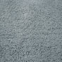 Close-up view of the Shag Organic Bath Rug by Coyuchi in light gray, featuring a fluffy, textured, soft, and dense pile surface that offers quick drying for everyday convenience.