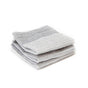 Three neatly folded Tidy Dish Cloths by Full Circle, made from light gray organic cotton with a waffle-textured scrubbing surface, displayed against a white background.