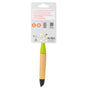 The Full Circle Micro Manager Detail Brush features a green neck, black tip, and bamboo handle, attached to white packaging listing features and certifications—an essential kitchen tool for spotless cleaning results.