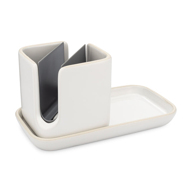 The Full Circle Ceramic Sinkside Caddy features a modern white ceramic design with a grey divider and comes with a matching rectangular tray, making it the ideal dish soap organizer for your countertop.