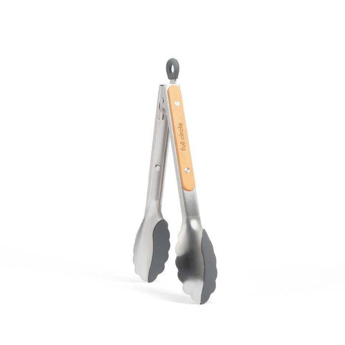 The Dual-Sided Tongs by Full Circle, featuring stainless steel with black silicone grips and a wood-accented handle, stand upright against a white backdrop. Perfect for your cookware collection.