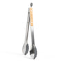 The Full Circle Dual-Sided Tongs feature silicone tips and a wooden grip, combining style and functionality. This elegant metal kitchen tool is displayed upright on a white background, showcasing its aesthetic appeal.