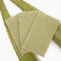 Three Full Circle Agave Leaf Scour Pads are placed atop two aloe vera leaves, showcasing an eco-friendly cleaning solution made from natural fibers. The background is white.
