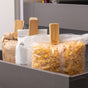 Three opened food bags—including cereal and flour—are securely sealed with Full Circle Bag Clips and stored upright in a gray kitchen drawer.