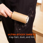 A hand uses the Full Circle Lint Lifter Roller Wand on black pants covered with pet hair. Orange text reads, ULTRA-STICKY SHEETS trap hair, dust, and lint with this eco-friendly lint remover.
