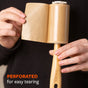 A person tears a perforated sheet from the Full Circle Lint Lifter Roller Wand, which features a bamboo handle. Text on the image reads, PERFORATED for easy tearing.