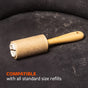 A pre-owned Full Circle Lint Lifter Roller Wand with a wooden handle rests on a dark, pet-hair-covered fabric surface. Orange text states: COMPATIBLE with all standard size refills.