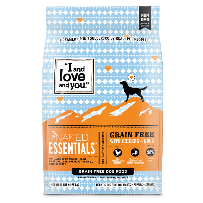 A bag of I and Love and You Naked Essentials Grain-Free Chicken and Duck Recipe Dry Dog Food, featuring orange/blue packaging with a dog silhouette on mountain peaks, plus Omega 3 & 6 fatty acids listed on the front.