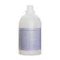 A large, translucent plastic bottle with a white cap and a purple label details ingredients and info for Rebel Green's Fresh Laundry Detergent Liquid - 3x Concentrated, an organic, gentle, sulfate-free laundry soap with a low-suds formula.