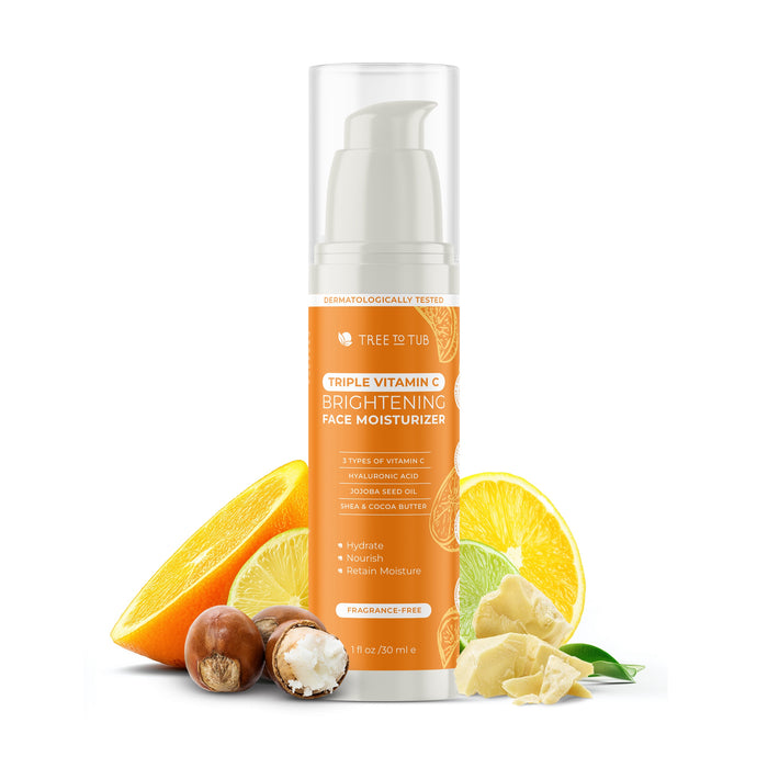 A bottle of Tree To Tub Brightening Face Moisturizer - Triple Vitamin C is shown with orange slices, a lemon wedge, shea butter, and macadamia nuts to highlight its natural ingredients and anti-aging benefits.