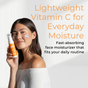 A woman in an off-shoulder white top, smiling with a cream streak on her cheek, holds Tree To Tub's Brightening Face Moisturizer - Triple Vitamin C. Text: “Lightweight, brightening daily moisturizer. Fast-absorbing and rejuvenating.”.