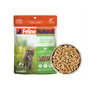 A package of Feline Natural Grain-Free, Freeze-Dried Cat Food by Feline Natural is shown beside a bowl of the dry, pellet-shaped food. The packaging displays a gray tabby cat and product information.