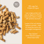 A pile of brown, stick-shaped Feline Natural Grain-Free, Freeze-Dried Cat Food sits on a tan background; text notes it’s 98% cage-free chicken and organs, grain free, low fat, easy to digest, and contains green mussels for health.