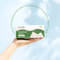 A hand holds a box of Fomin Clean Facial Towels Bamboo against a light blue background. Green text above reads: Reduce the transfer of bacteria that contribute to acne.