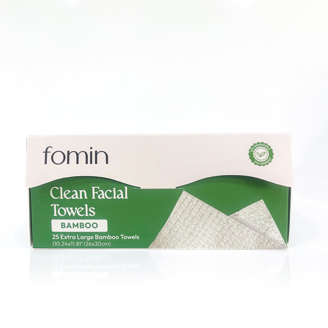 A box of Fomin Clean Facial Towels Bamboo, featuring a green and white design and containing 25 extra large plant-based facial towels. A disposable face towel is pictured on the front of the box.