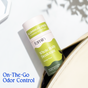 A Fomin Deodorant Stick peeks out of an open beige bag with “On-The-Go Odor Control” in blue—a convenient, eco-friendly choice for staying fresh while traveling.