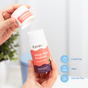 A hand holds a Fomin Deodorant Stick with the cap off. The Magnolia Neroli scent, eco-friendly, cruelty-free, vegan formula, and effective odor neutralizing are highlighted by bold icons on the stick.
